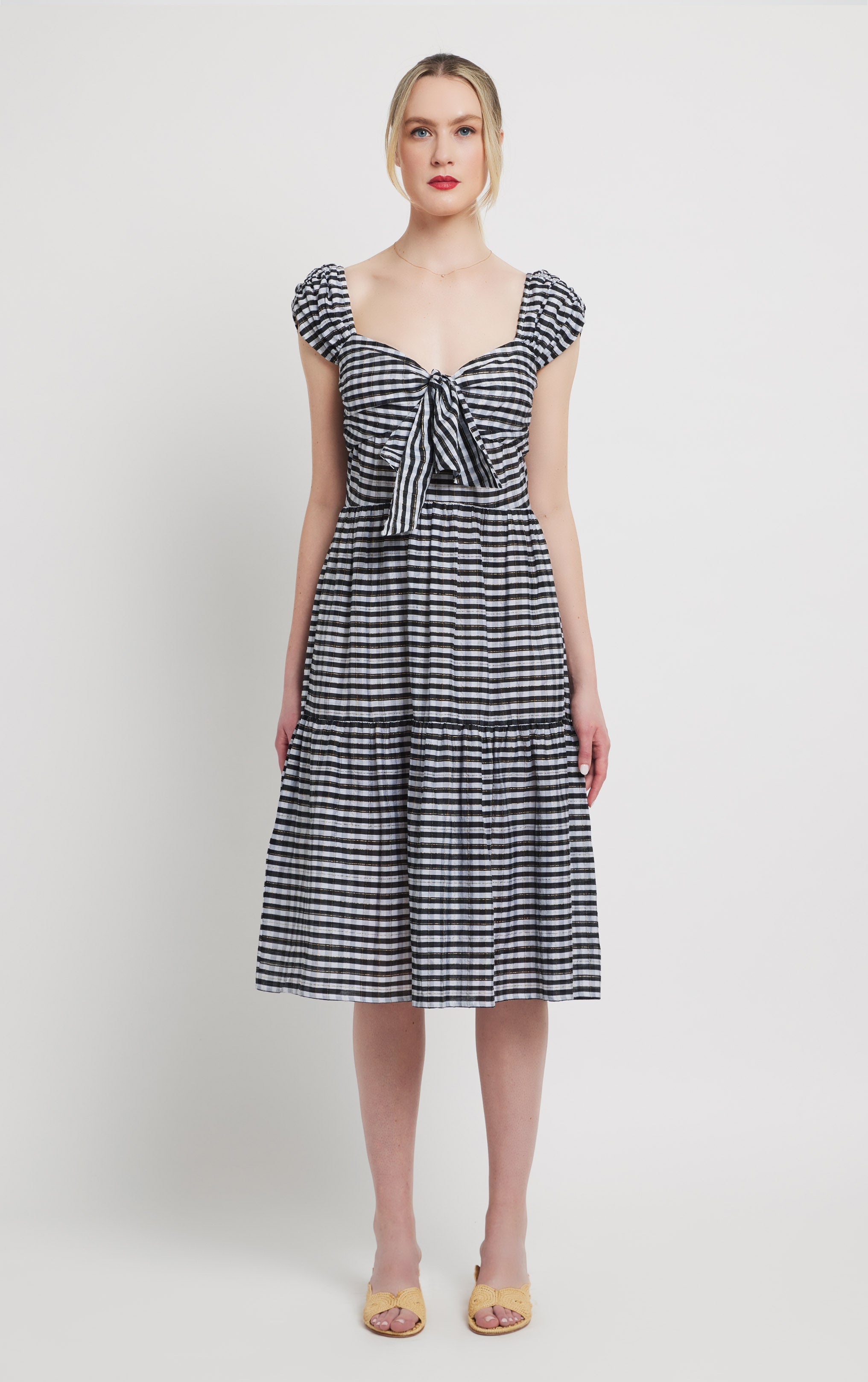 front view of black and white cotton and silk blend dress with pockets, front tie detail and rusched shoulder.