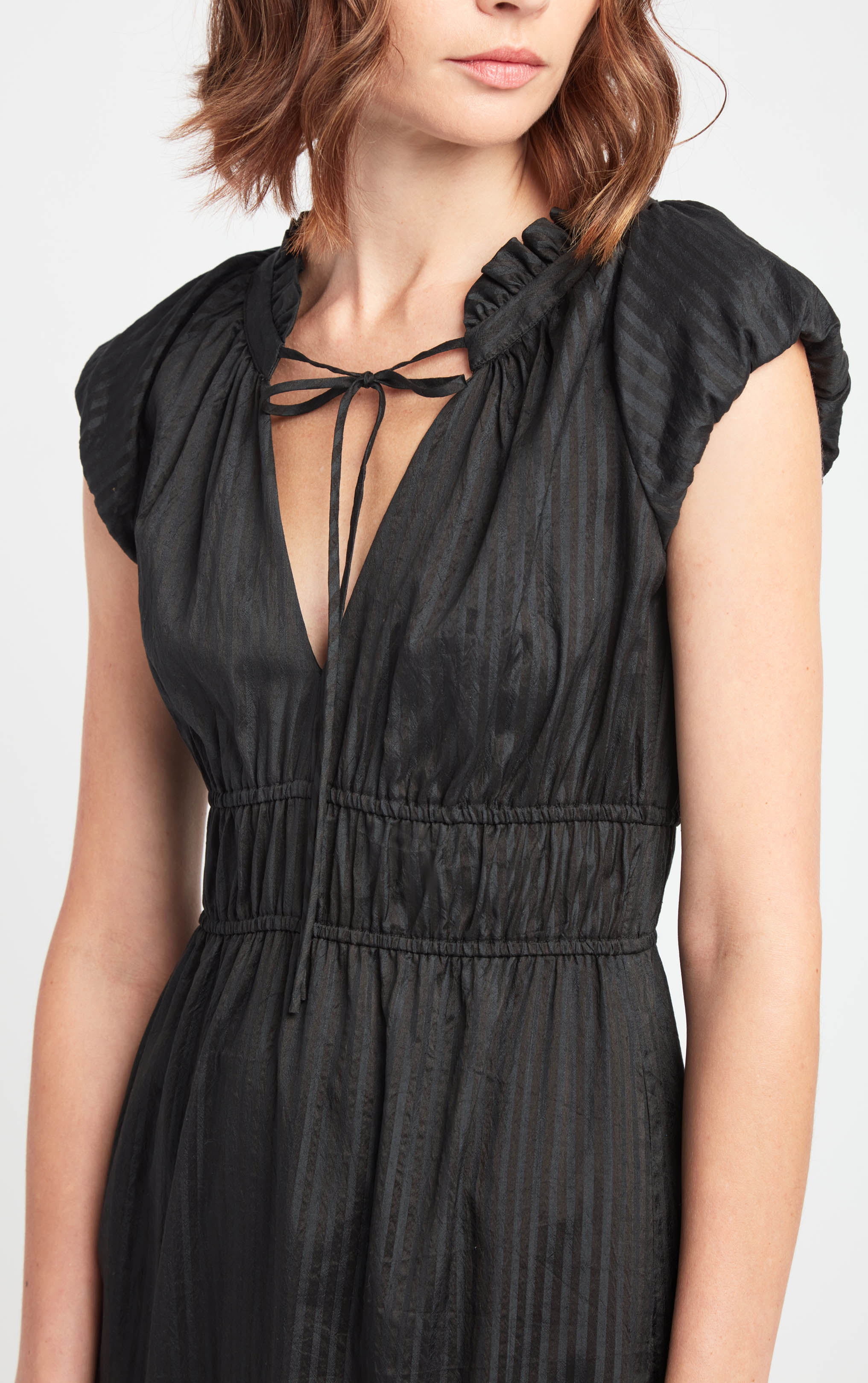 front close up profile of woman wearing black sleeveless cotton silk