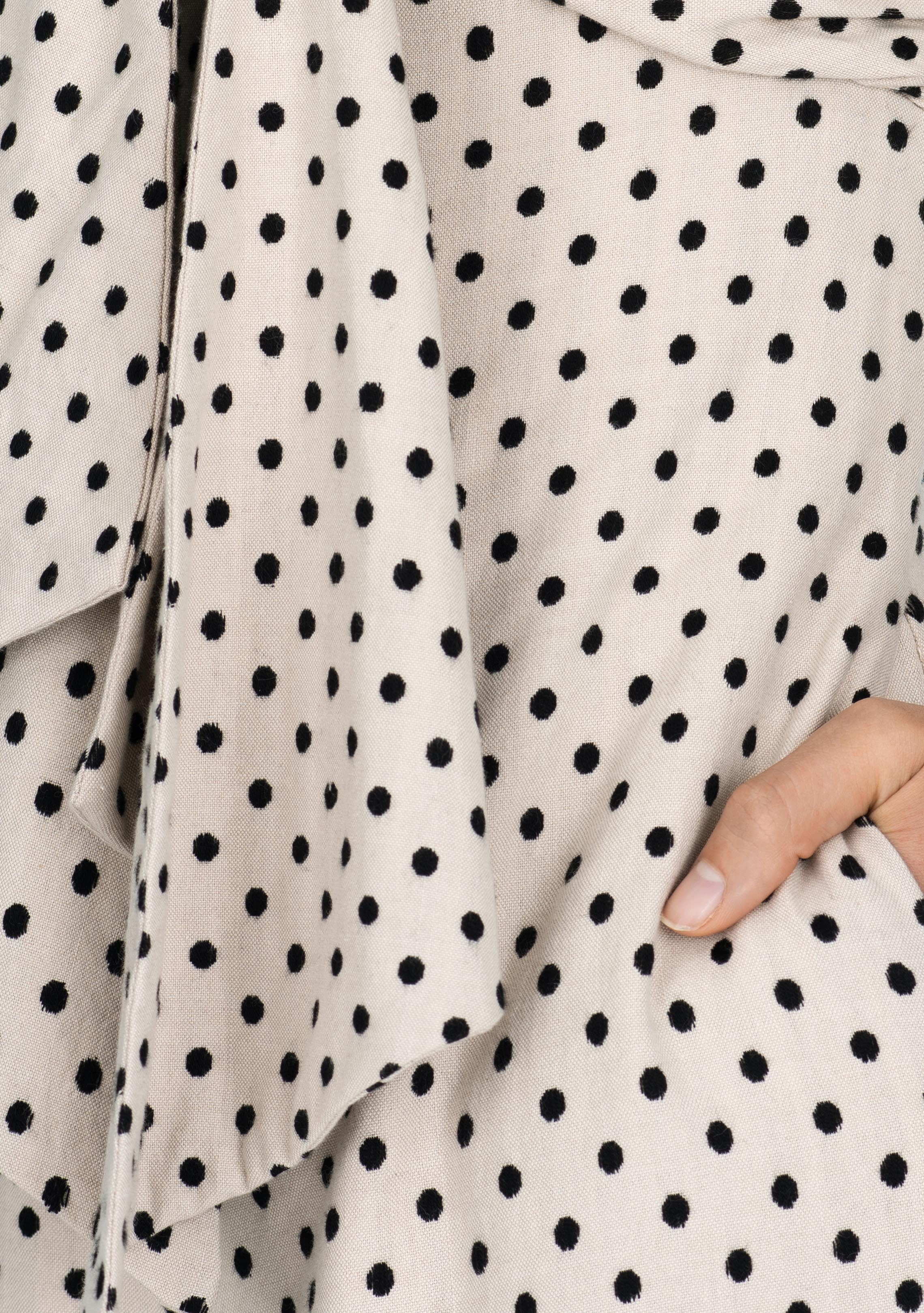 close up view of beige and black polka dot handwoven cotton silk jumpsuit with tie up front