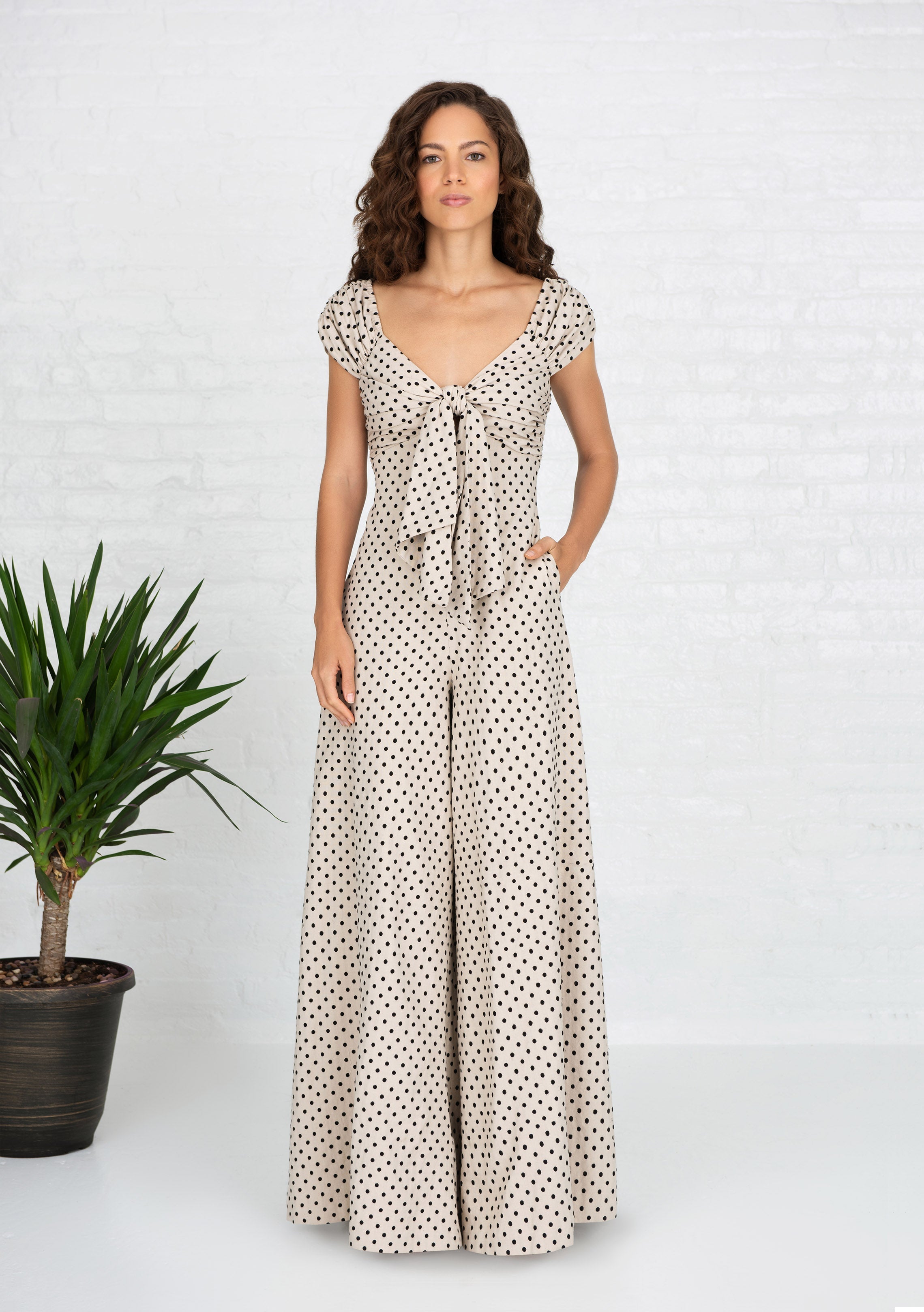 woman wearing beige and black polka dot handwoven cotton silk jumpsuit with her hand in her pocket